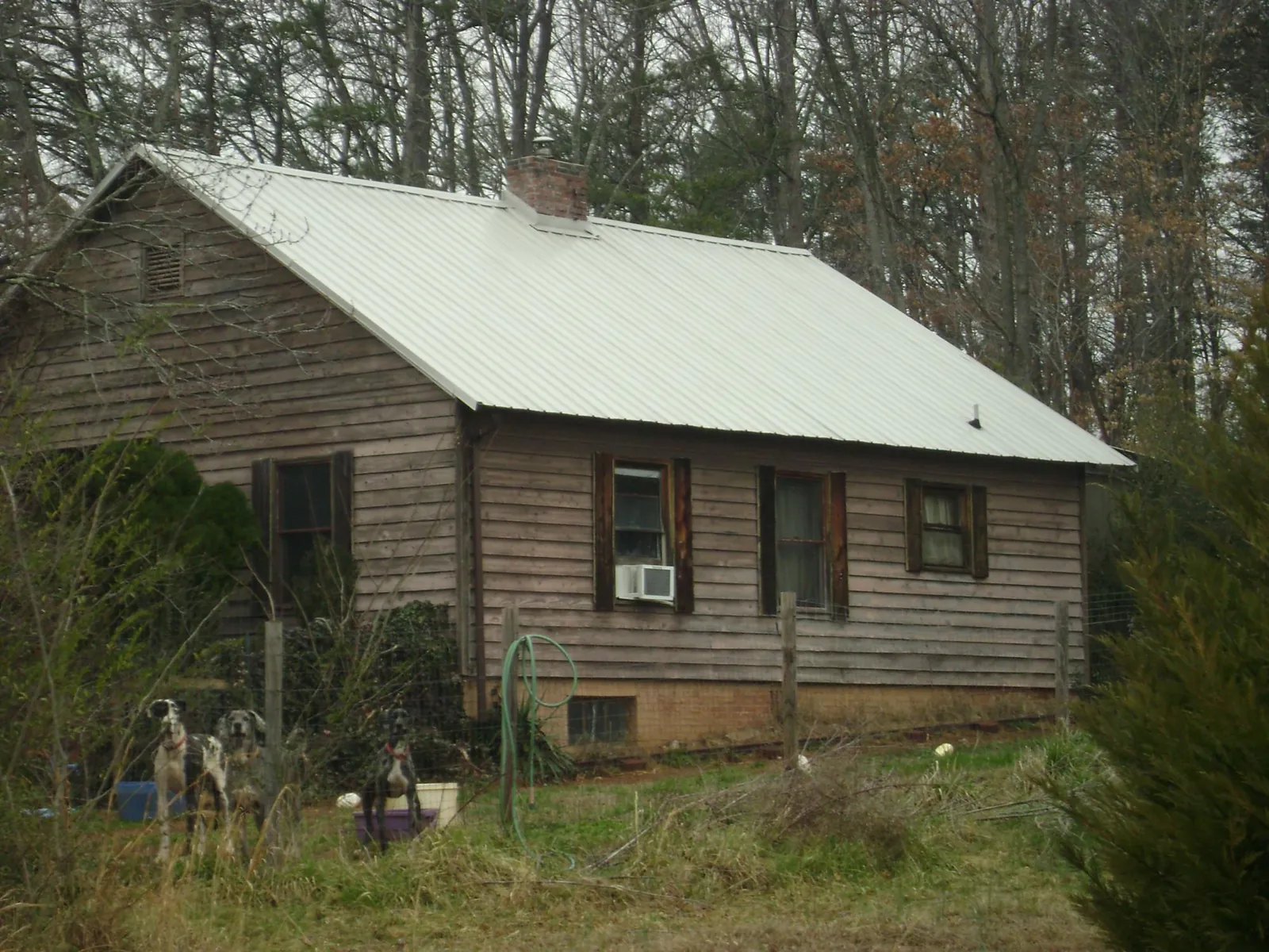 White metal roof on an old wood sided farmhouse, from a Metal Roof Installation job in Mallory